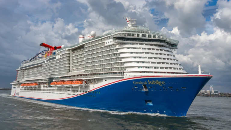 Close bow view of Carnival Jubilee beneath dramatic clouds