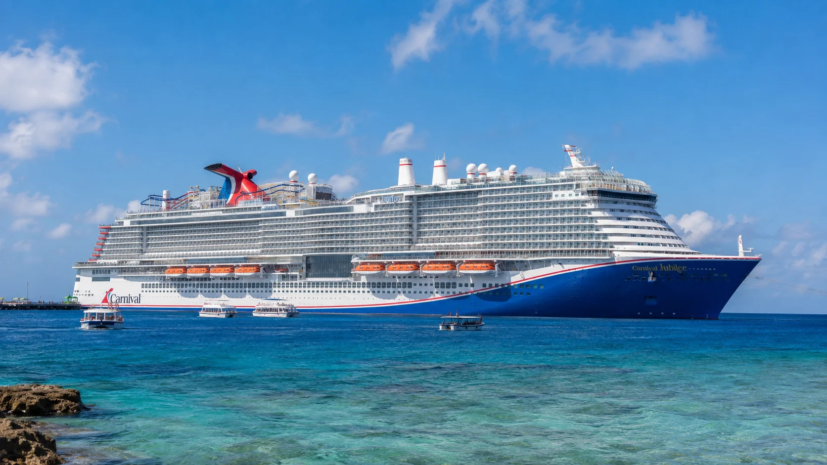 Carnival Jubilee seen broadside across bright turquoise water