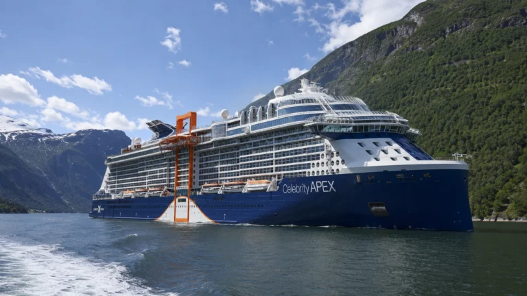 Celebrity Apex sailing through a steep mountain fjord
