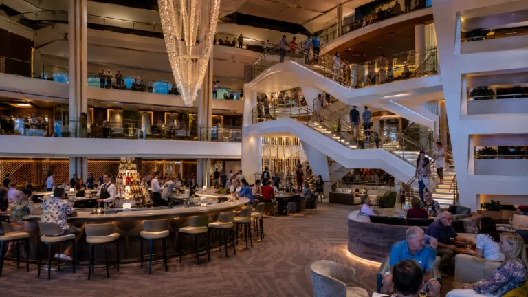 Celebrity Apex Grand Plaza with central bar and sweeping staircase