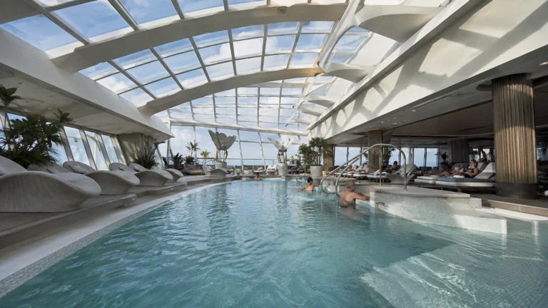 Indoor pool and loungers in the Celebrity Apex Solarium