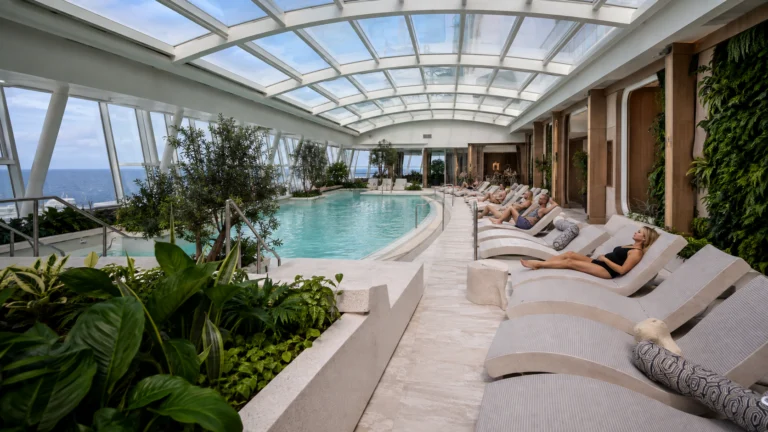 Indoor pool and loungers in the Celebrity Beyond Solarium