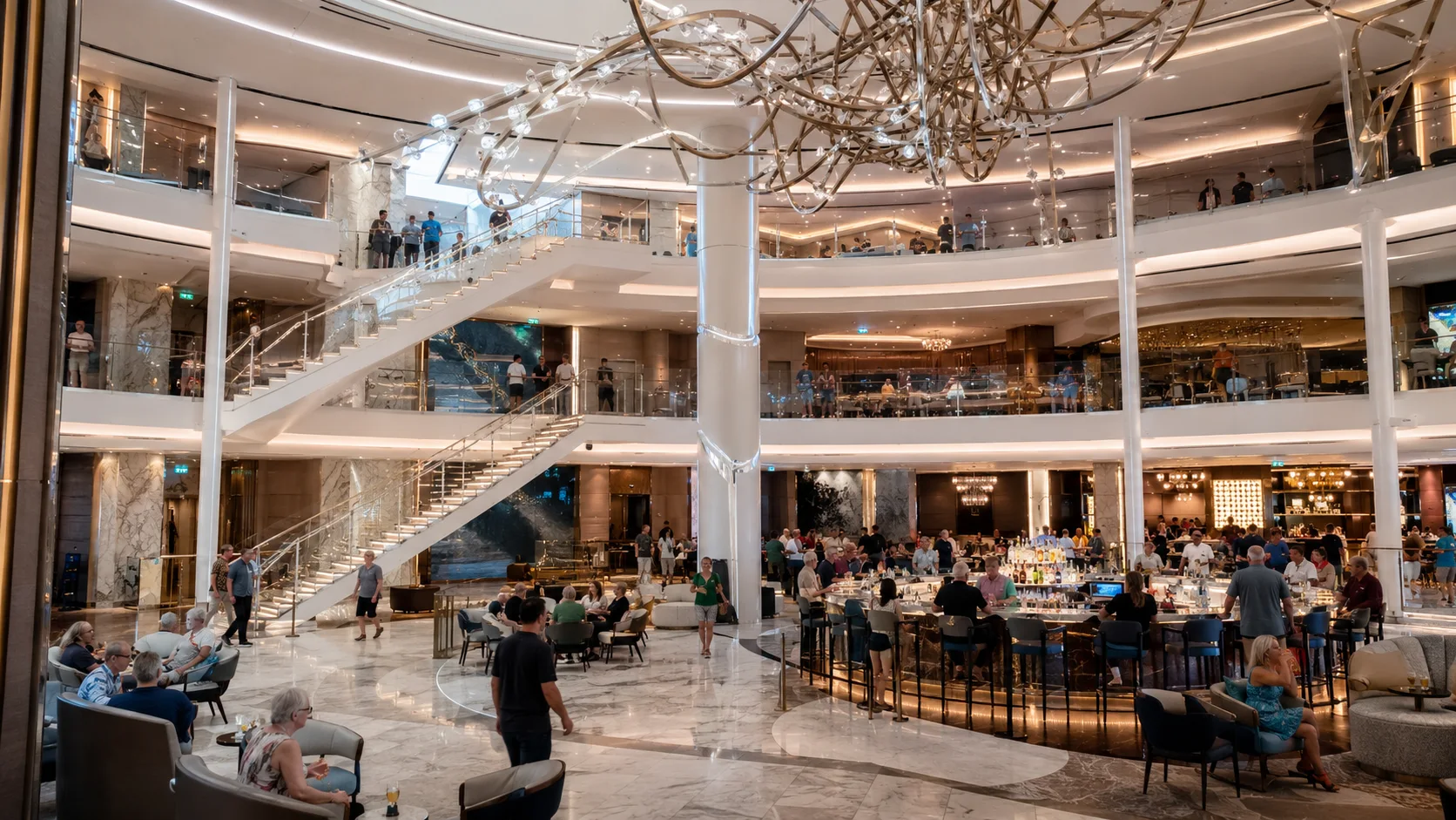 Celebrity Edge Grand Plaza with central bar and sweeping staircase