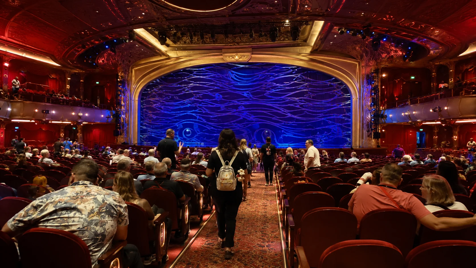 Audience waiting for a show in the Walt Disney Theater aboard Disney Destiny