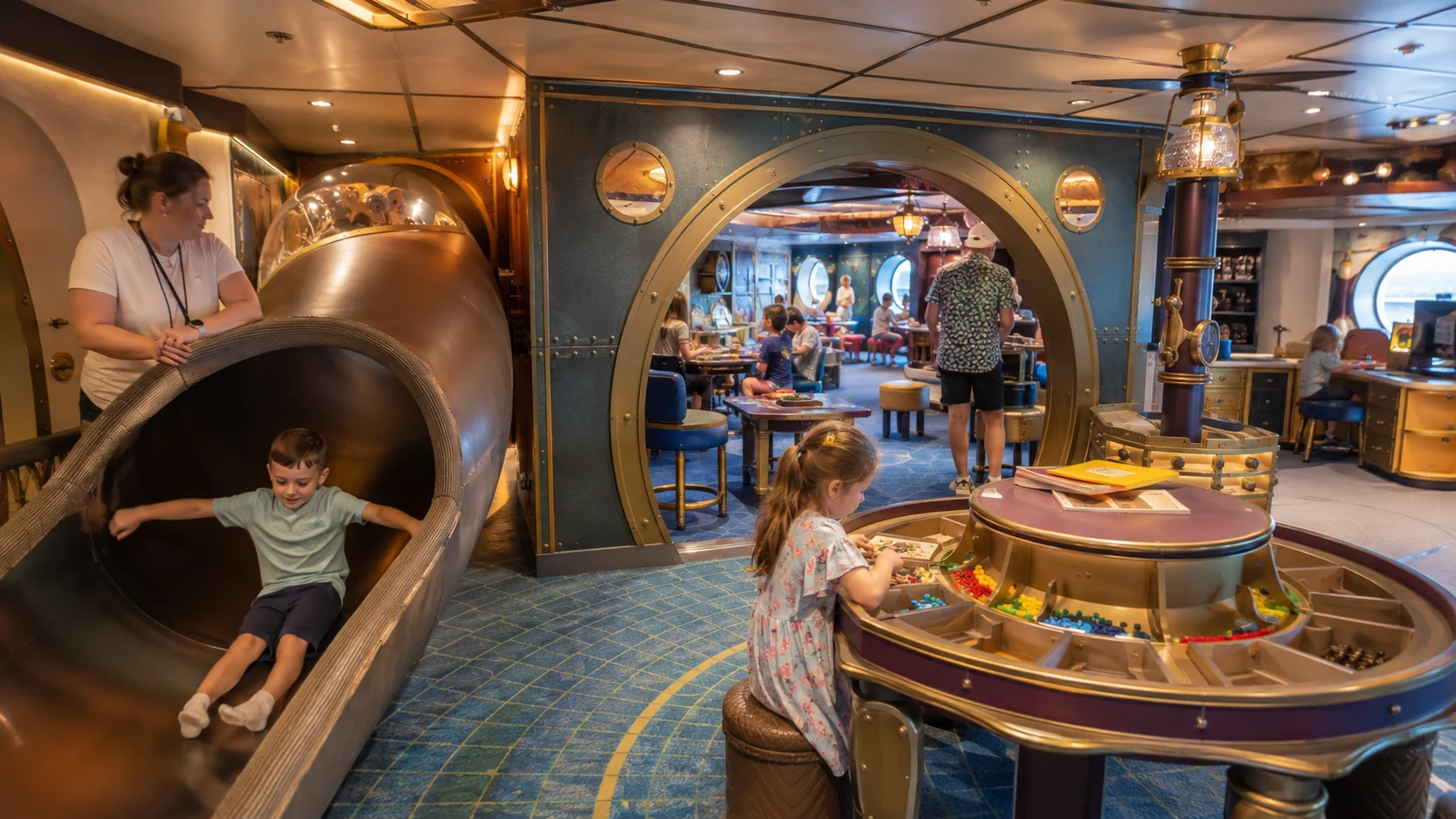Child sliding into Disney's Oceaneer Club aboard Disney Treasure
