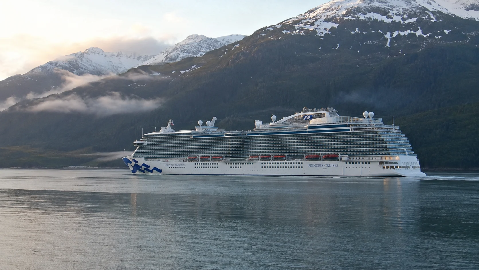 Majestic Princess sailing through a mountain-lined fjord