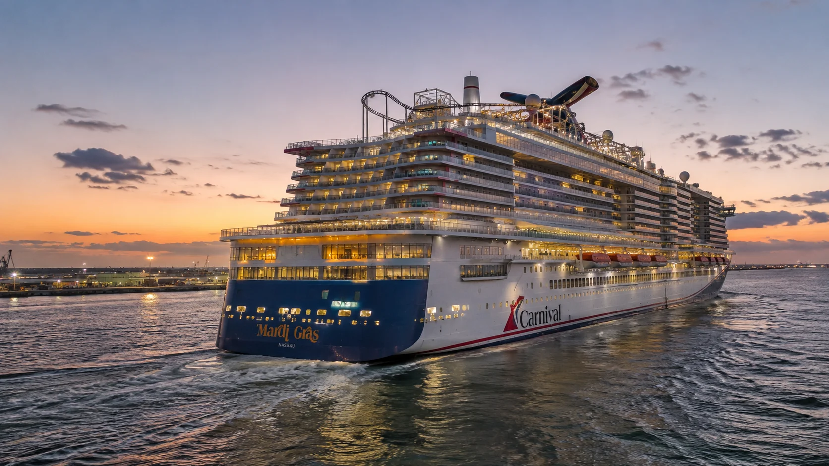 Stern of Mardi Gras glowing with lights at sunset
