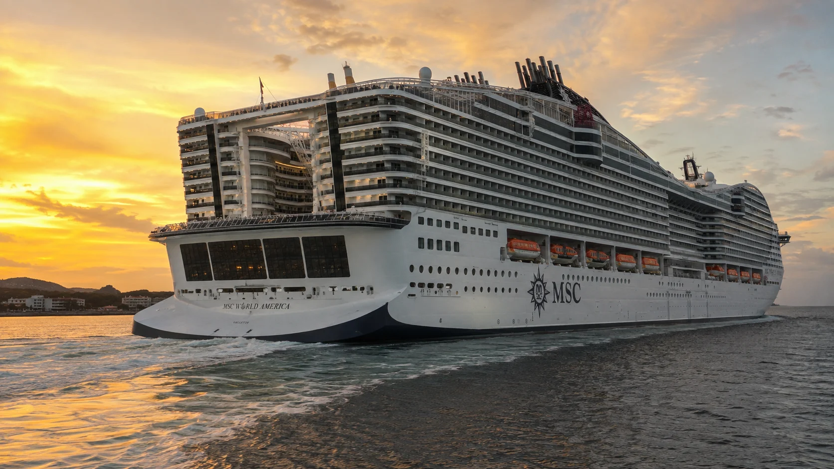 MSC World America sailing at sunset