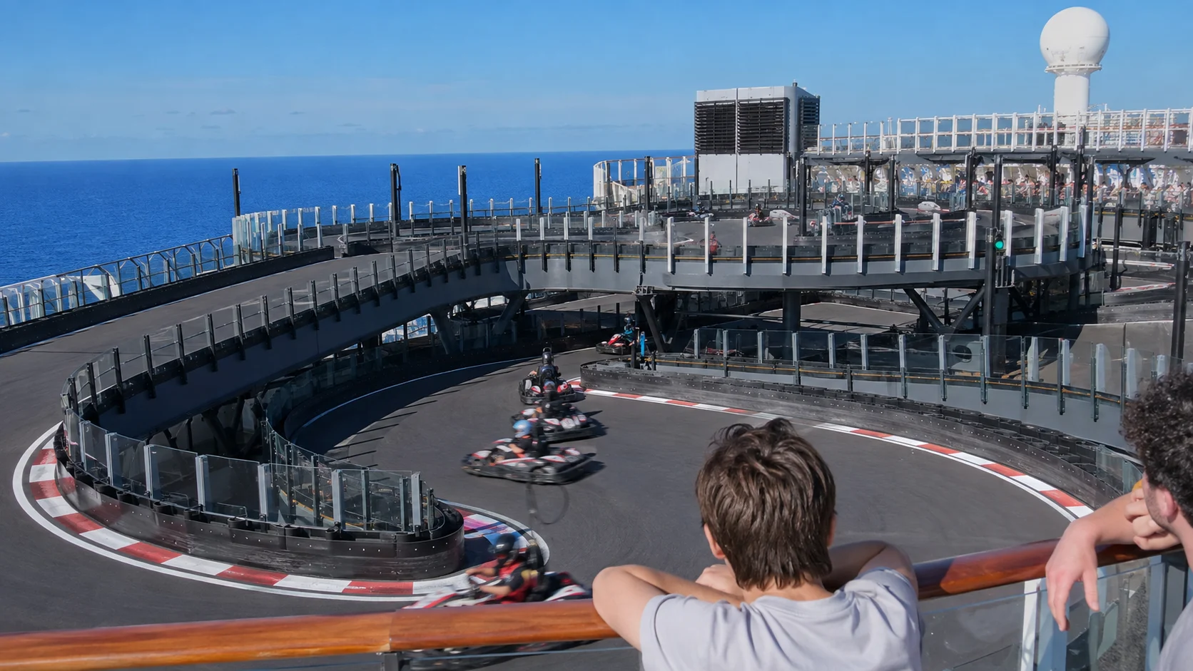 Passengers racing go-karts on the Norwegian Encore Speedway