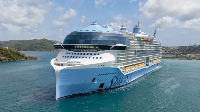 Star of the Seas sailing toward a green coastline