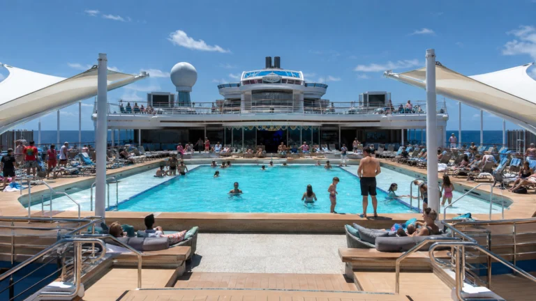 Passengers swimming and sunbathing on the Sun Princess Lido pool deck