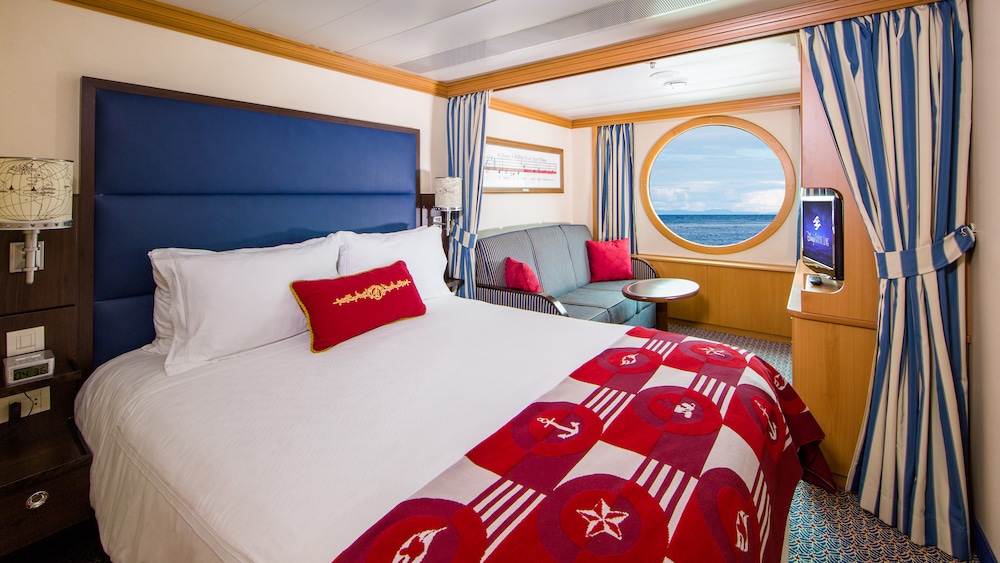 Representative Disney Magic Deluxe Oceanview room with large porthole