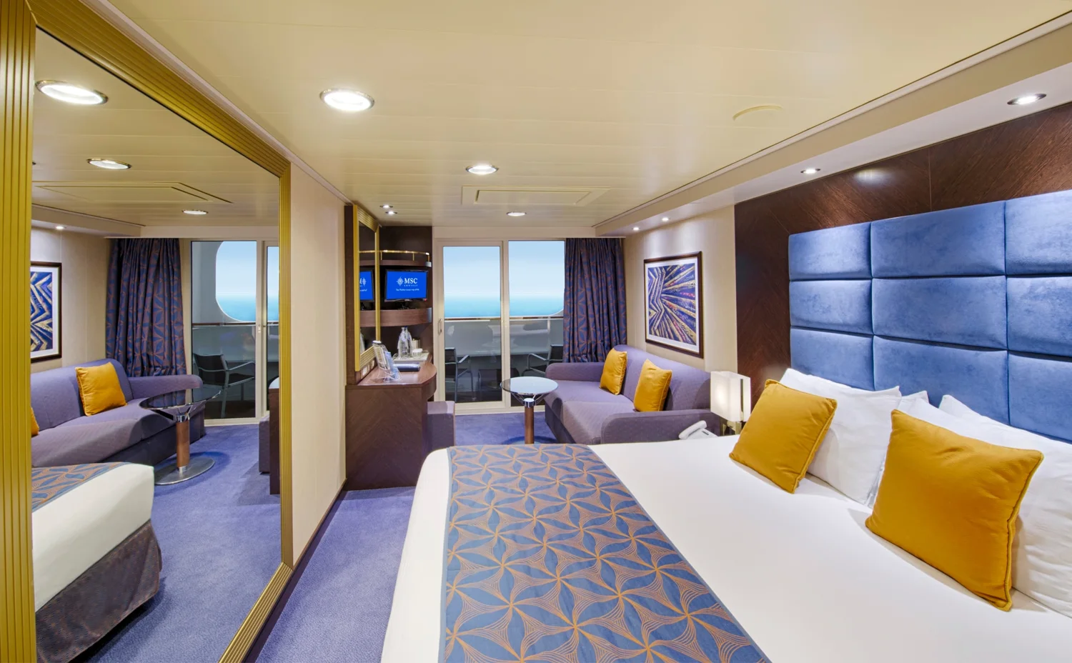 Representative MSC Divina balcony stateroom with a bed and sofa